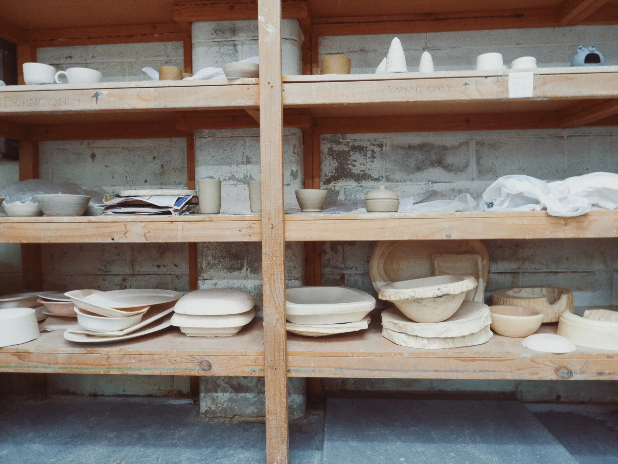 Studio shelves with finished pottery